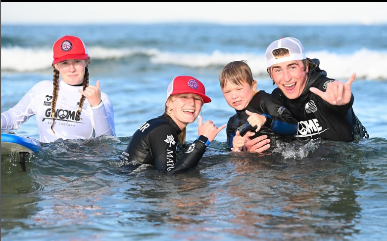 Gnome Surf® goodies collection featuring socks, candy, stickers, backpacks, and fun surf extras that spread joy while supporting surf therapy programs.
